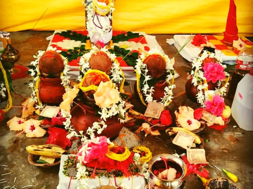 Flower-adorned ritual vessels in a Narayan Bali setting