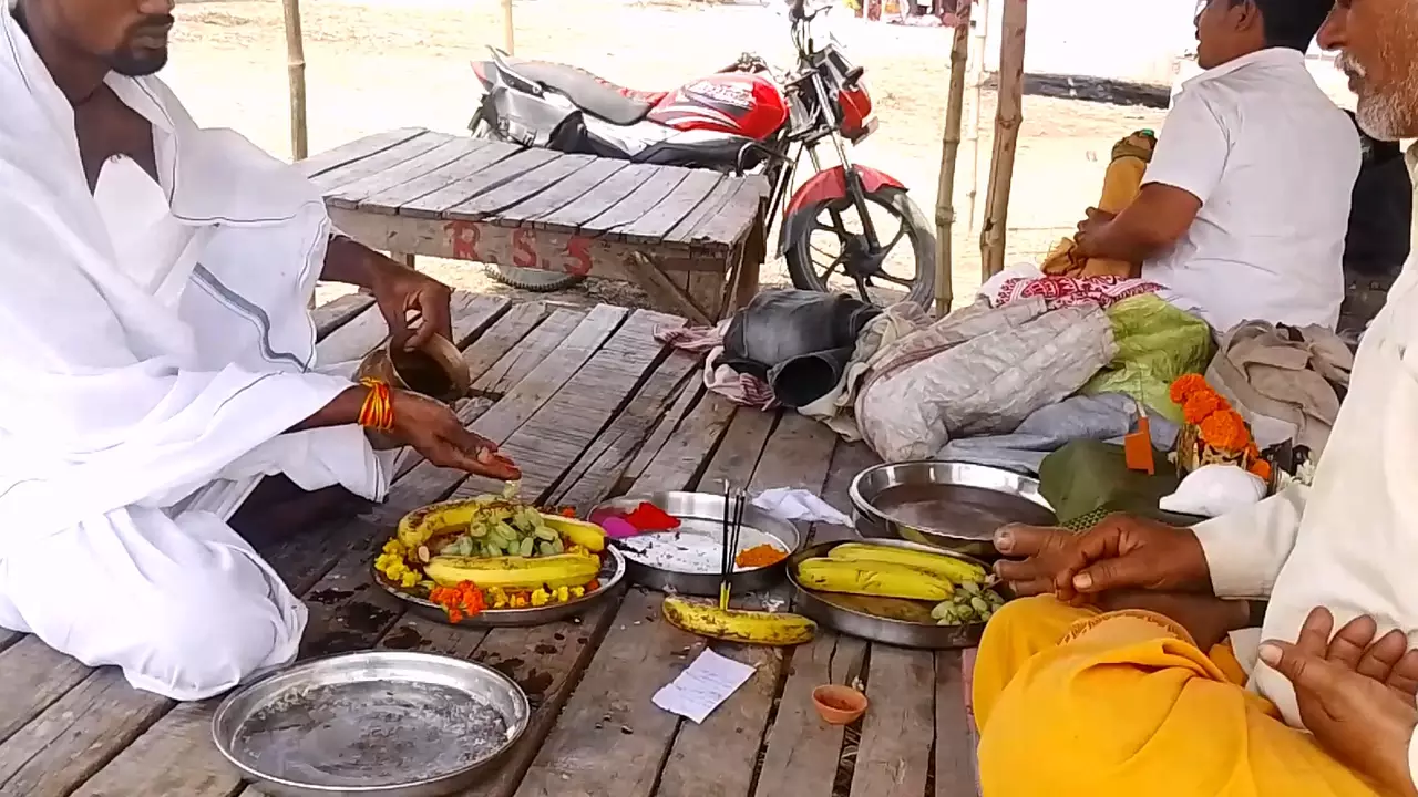 Men performing Tarpan, offering fruits and water to honor ancestors