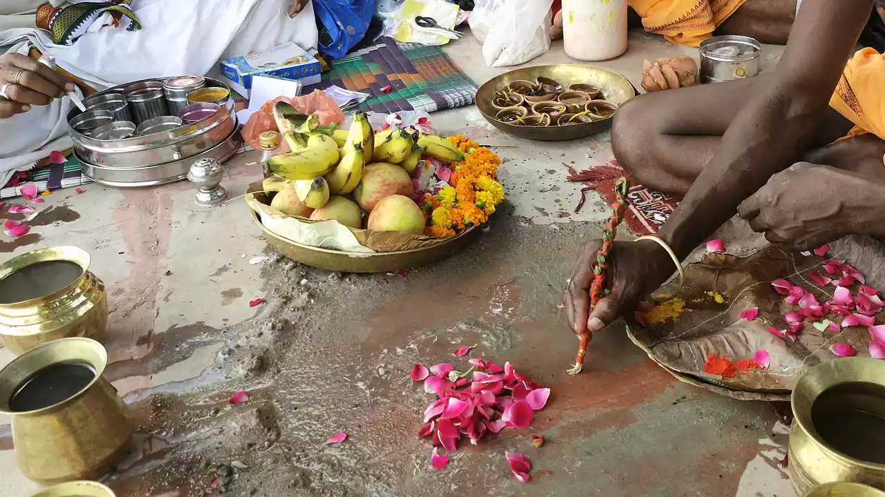 Image of Sradh ritual preparations with fruits, flowers, water (Tarpan), and lamps- Vishwadevas in Shradh 