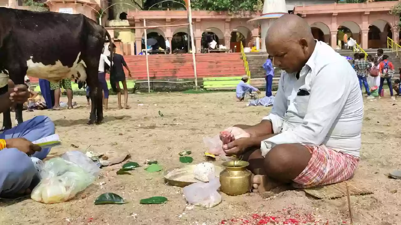 Image of a person doing pind daan near the ghats-The Hindu Concept of Pitrus