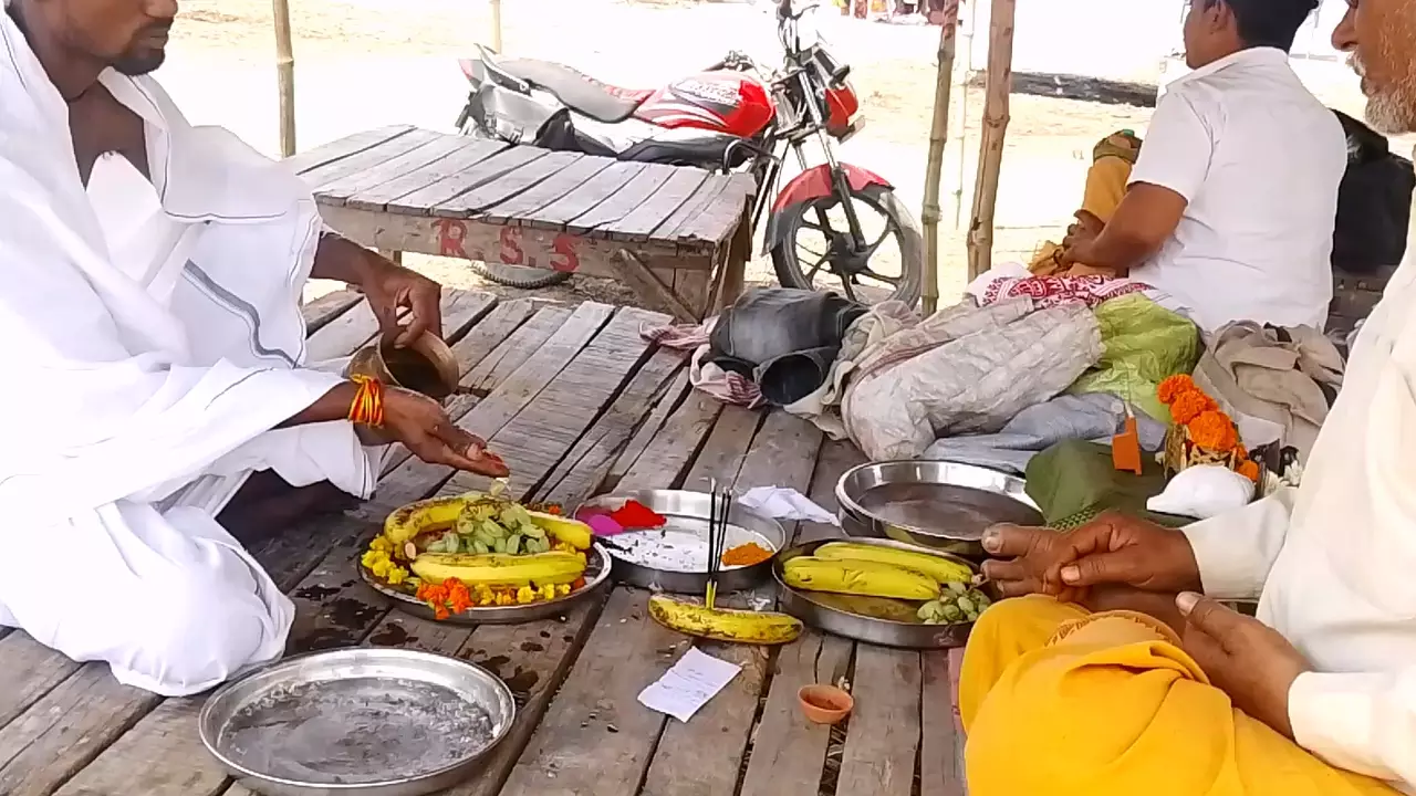 Images of Men performing Tarpan, offering fruits and water to honor ancestors- Purpose of Tarpan