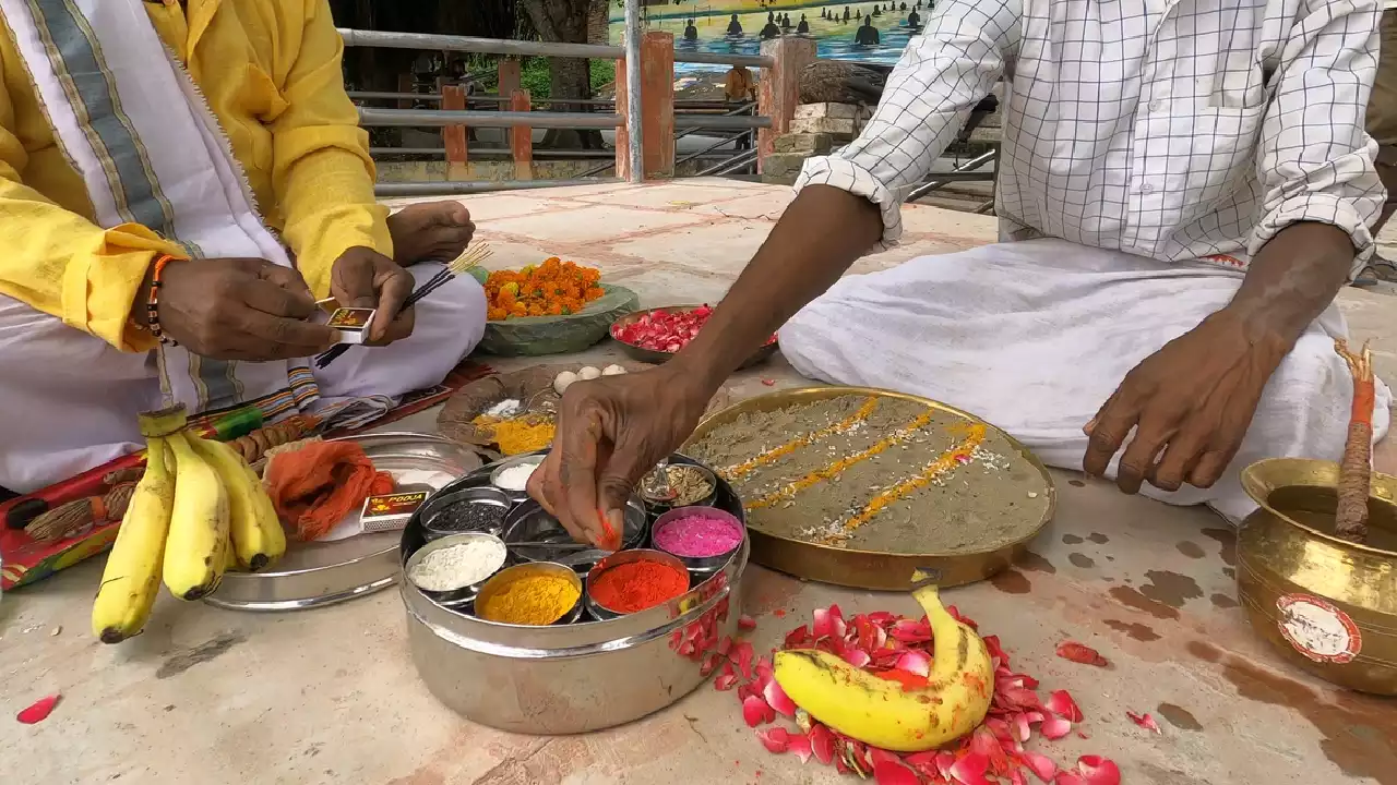 Image of Men performing Shradh ritual, preparing offerings like Pindas, fruits, flowers, and rang- Pinda symbolism meaning