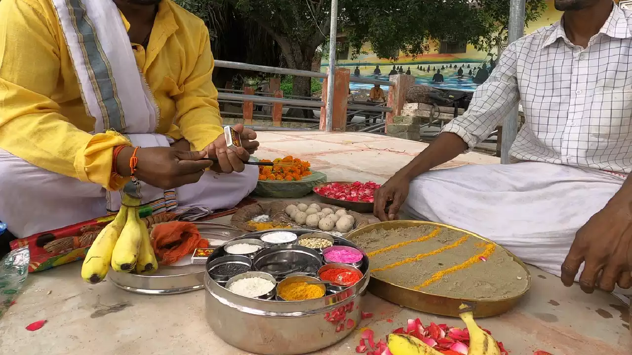 Pind Daan ritual: Two men preparing offerings like Pindas, fruit, flowers, powders, altar- Pind Daan ritual steps